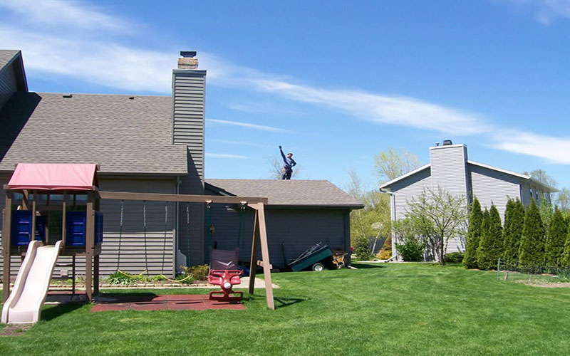 Crew installing new roofing on a home
